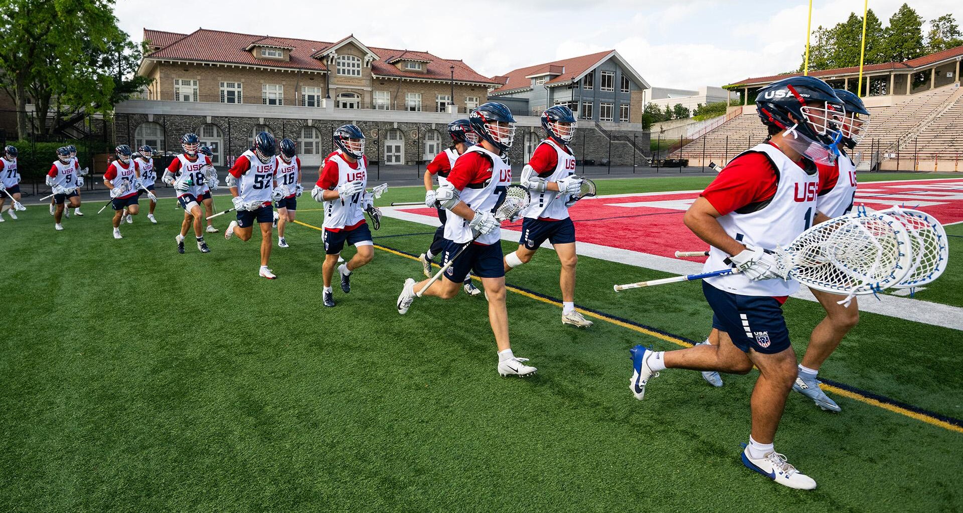 USA U20 lacrosse players run onto the field at a training camp at Cornell University