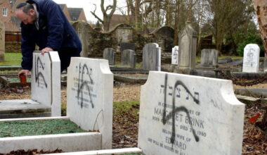 Melvyn Hartog, Head of Burial for the United Synagogues of the UK, looks at three graves vandalized with the Nazi Swastika at the Jewish Cemetary in Aldershot, Hampshire, England, 18 January, 2005. About a dozen graves were vandalized.