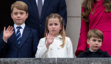 Prince George wears a navy suit with a striped tie, Princess Charlotte wears a white coat, and Prince Louis looks bored