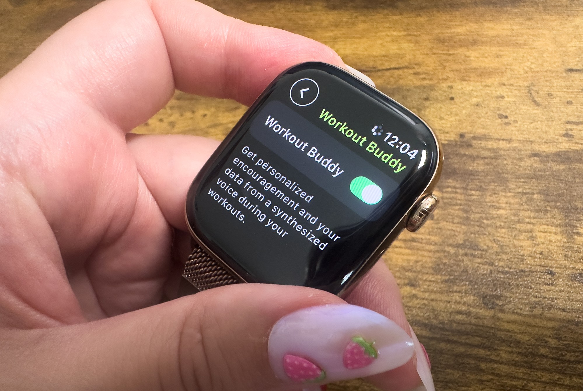Top-down view of the Workout buddy option in the native Workout app on an Apple Watch Ultra 2. It shows the feature toggled on and reads “Get personalized encouragement and data from a synthesized voice during your workouts.”