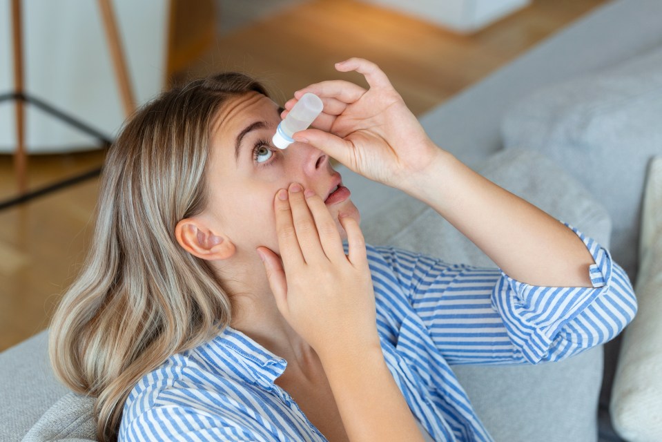 Woman applying eye drops.