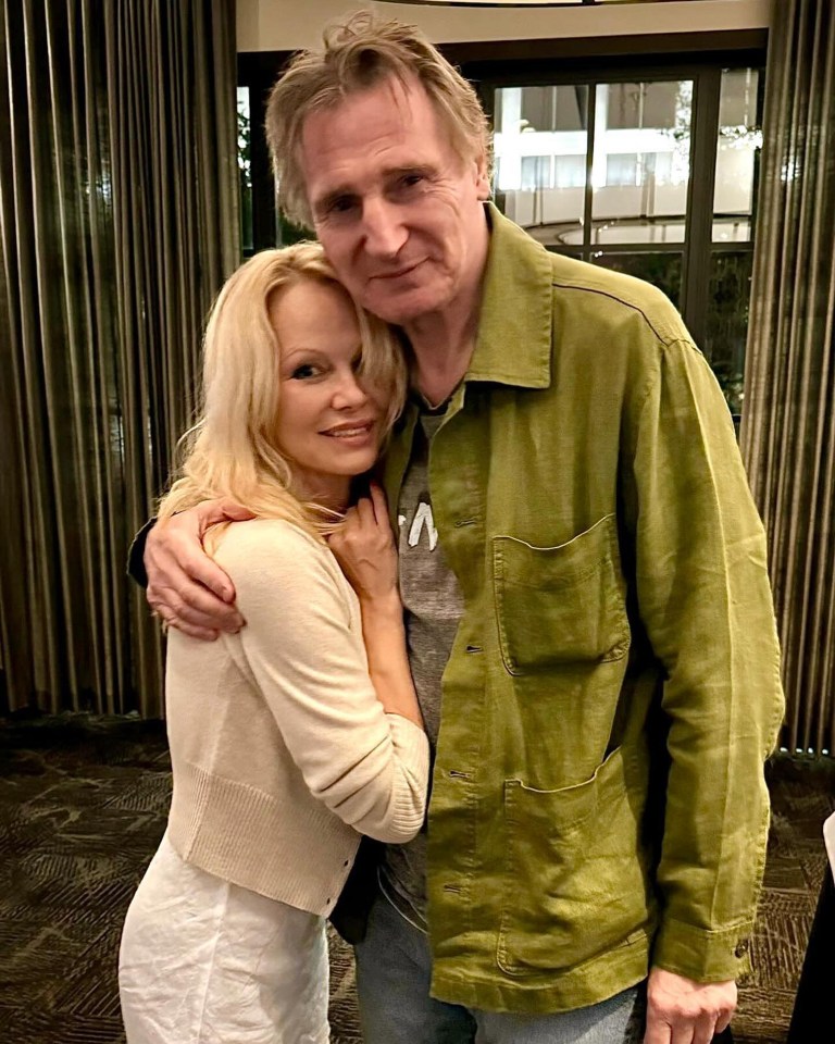 Pamela Anderson and Liam Neeson embracing.
