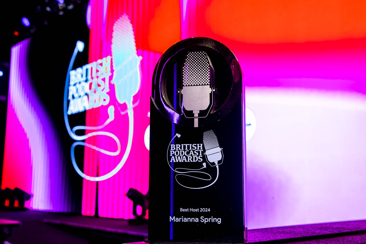 An award in front of the stage at the British Podcast Awards