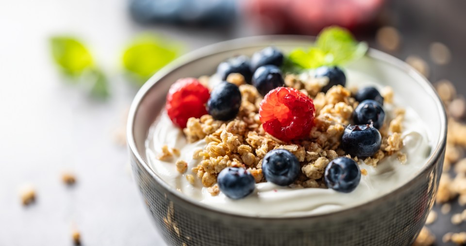 Yogurt parfait with granola, raspberries, and blueberries.