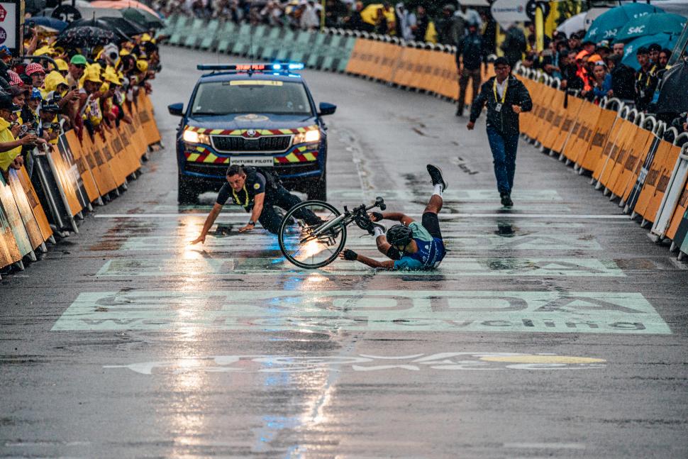 “Prankster” invades Tour de France finish on bike and tackled by police after jumping barriers moments before sprint