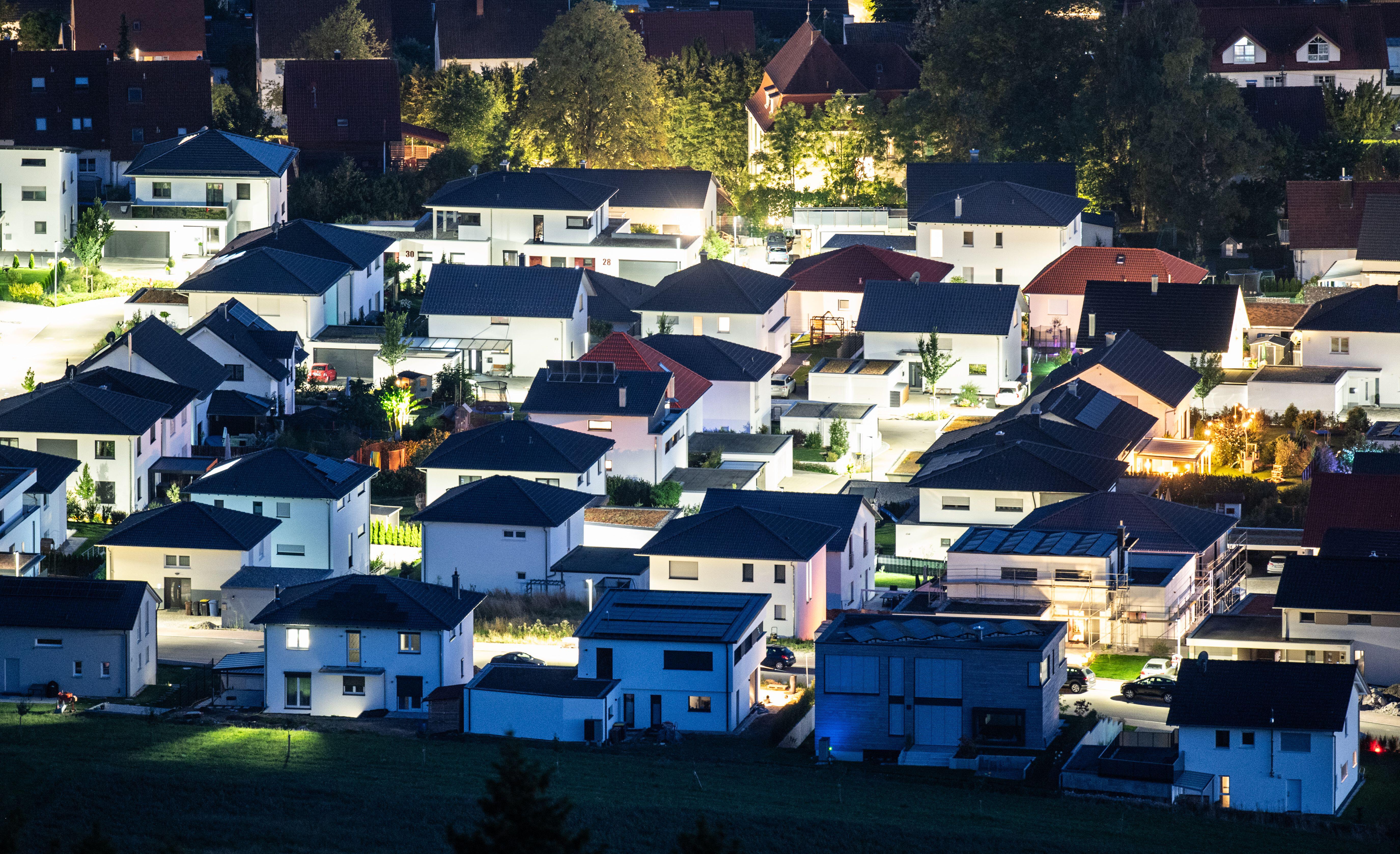 Aerial view of illuminated residential buildings at night.