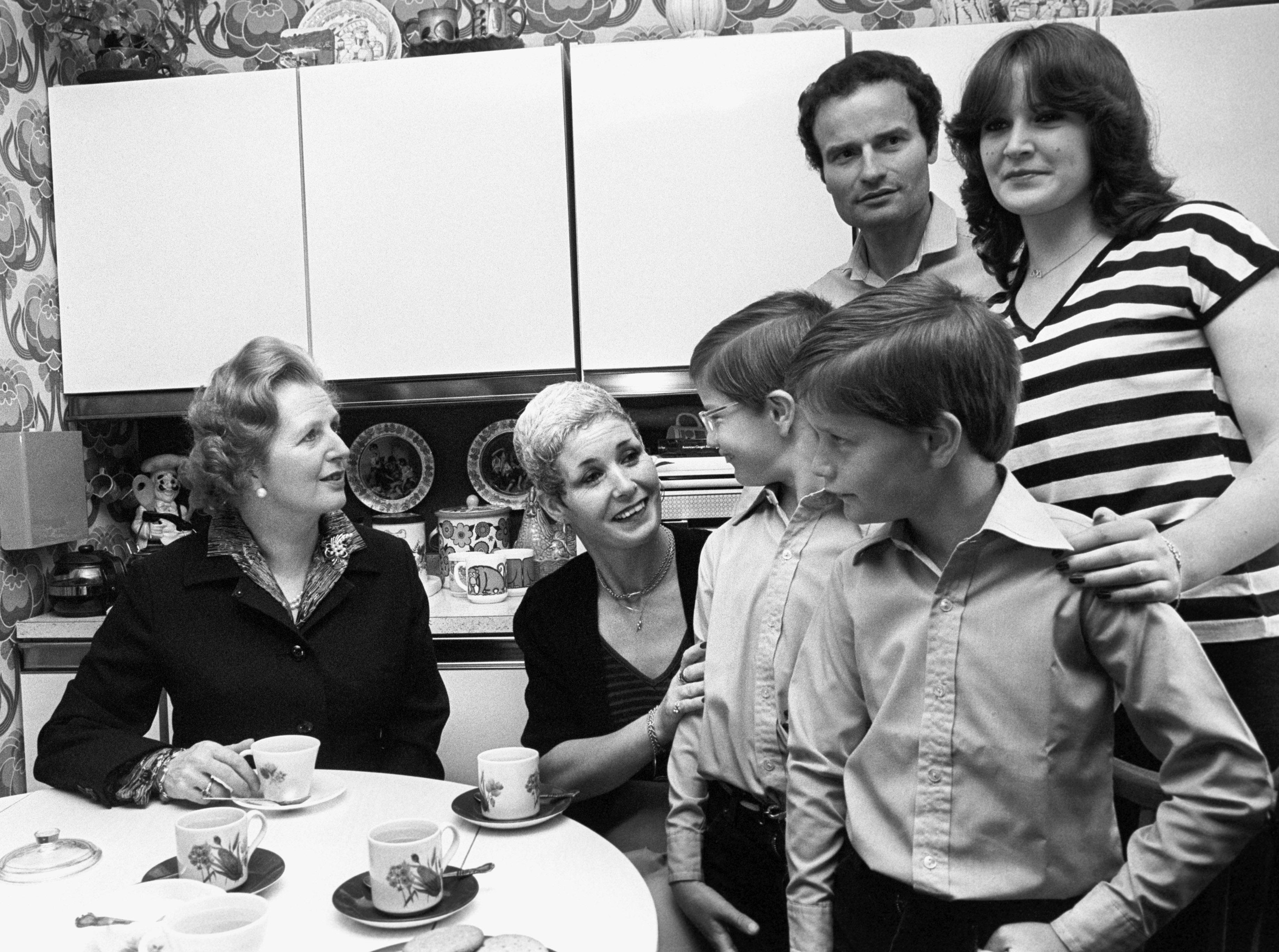 Prime Minister Margaret Thatcher (l), after she handed over a copy of the deeds of 39 Amersham Road, Harold Hill to the Greater London Council's 12,000th council house buyer, James Patterson and his wife Maureen. With them are their three children, t