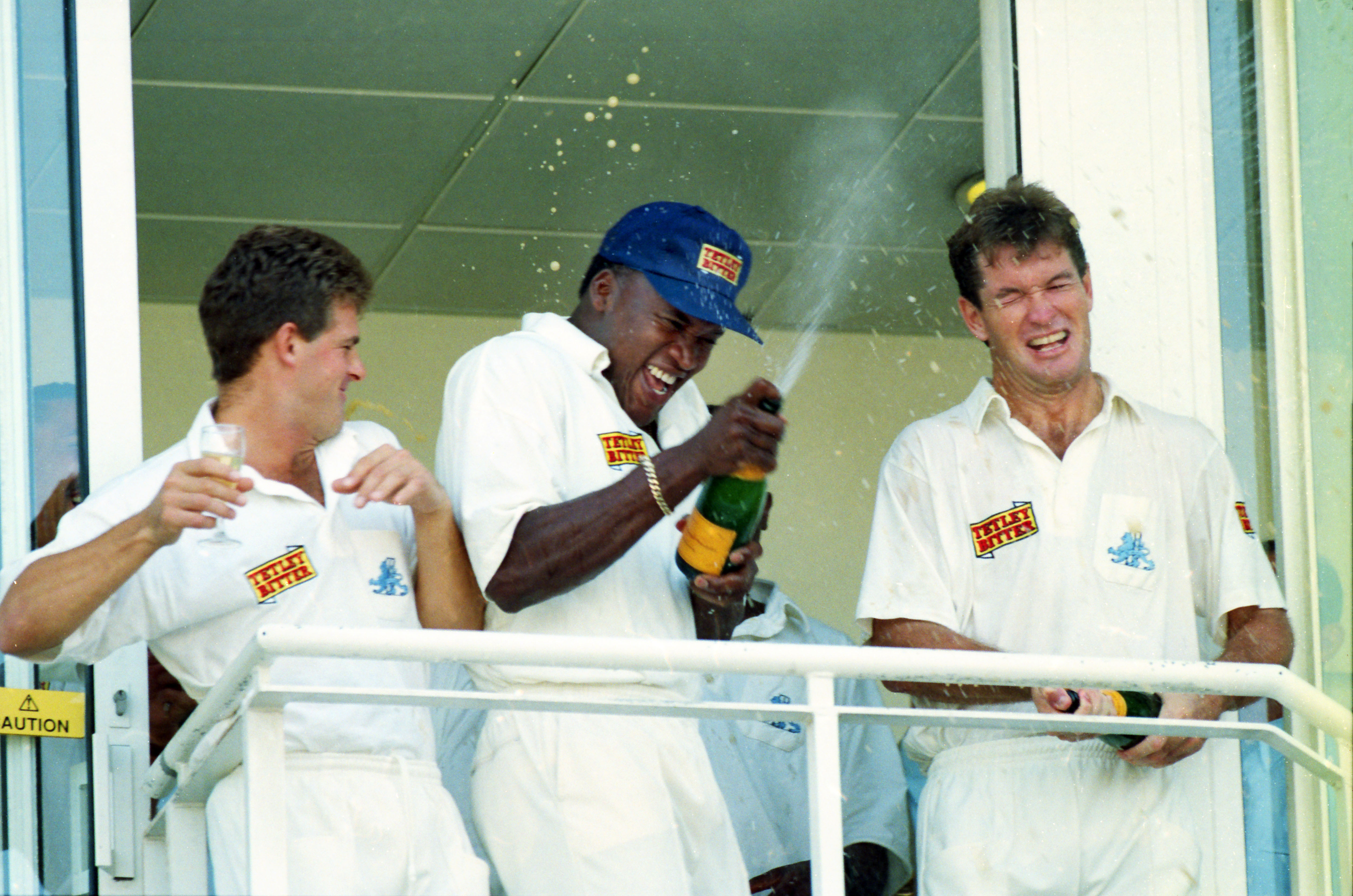 Cricket players celebrating a victory with champagne.