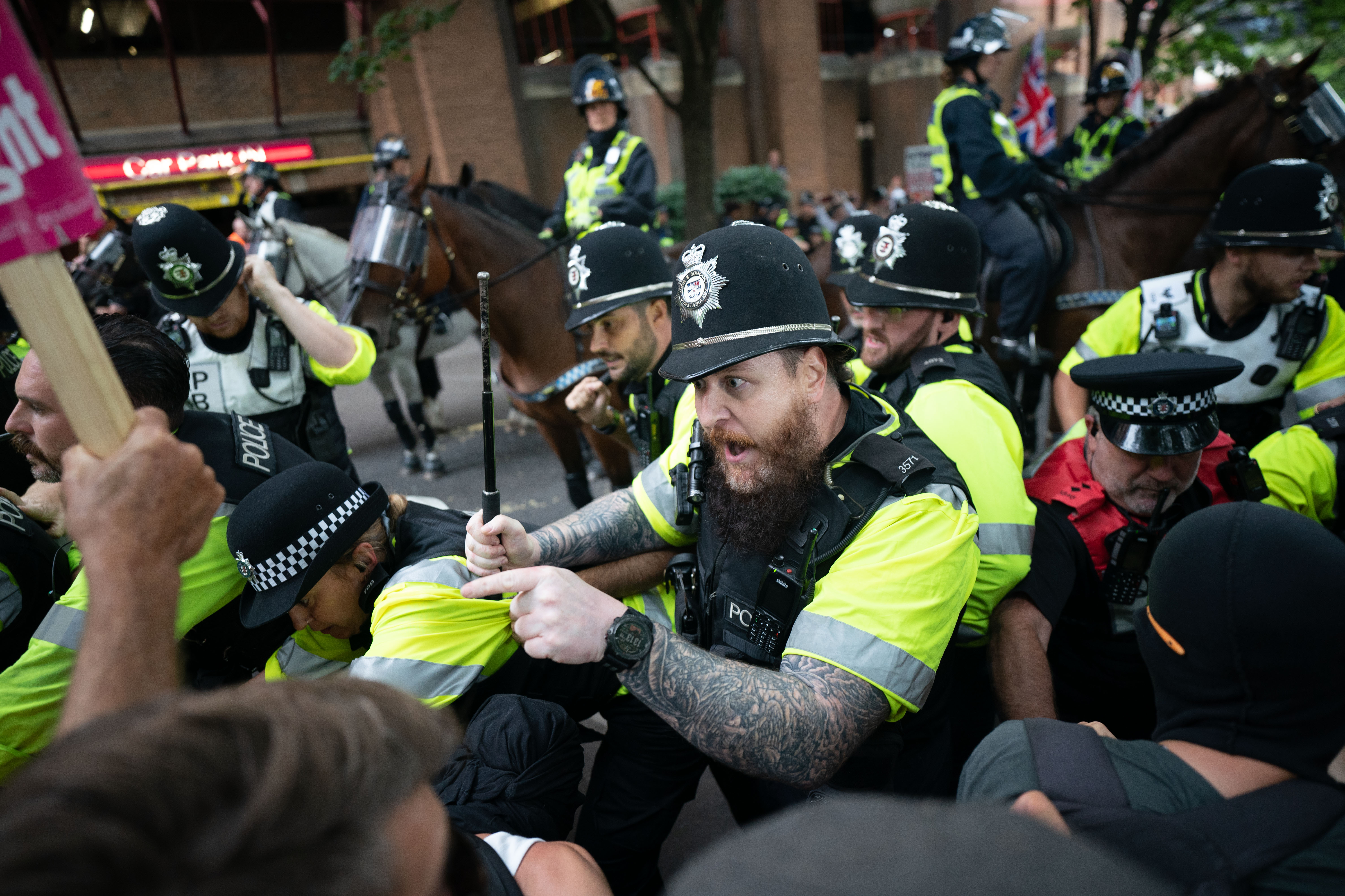Police officers scuffle with demonstrators in Bristol on Saturday