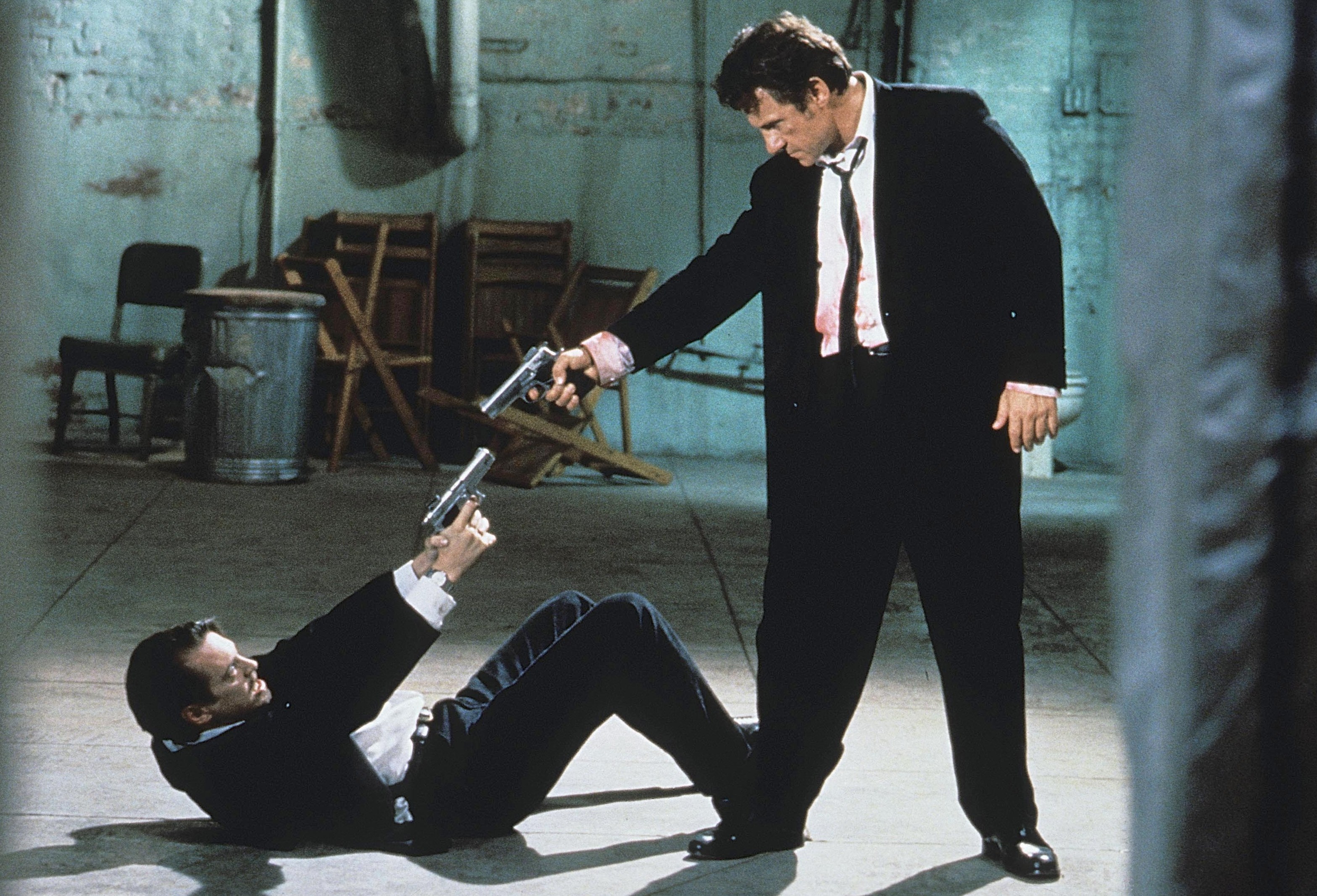 Still from Reservoir Dogs showing Steve Buscemi and Harvey Keitel in a tense scene.