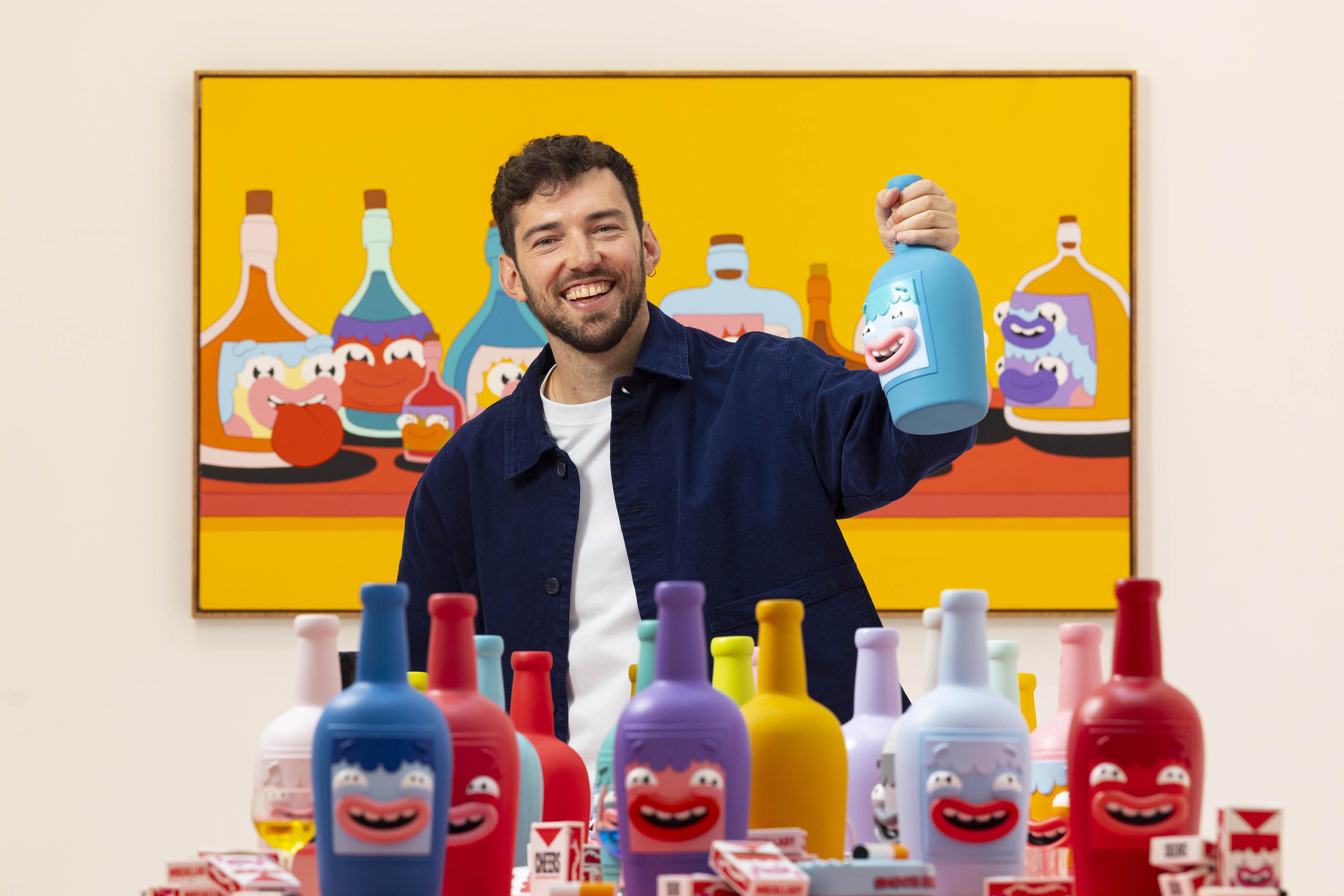MrCallaby at his new exhibition, "Cheers," showcasing cartoon-designed bottles.