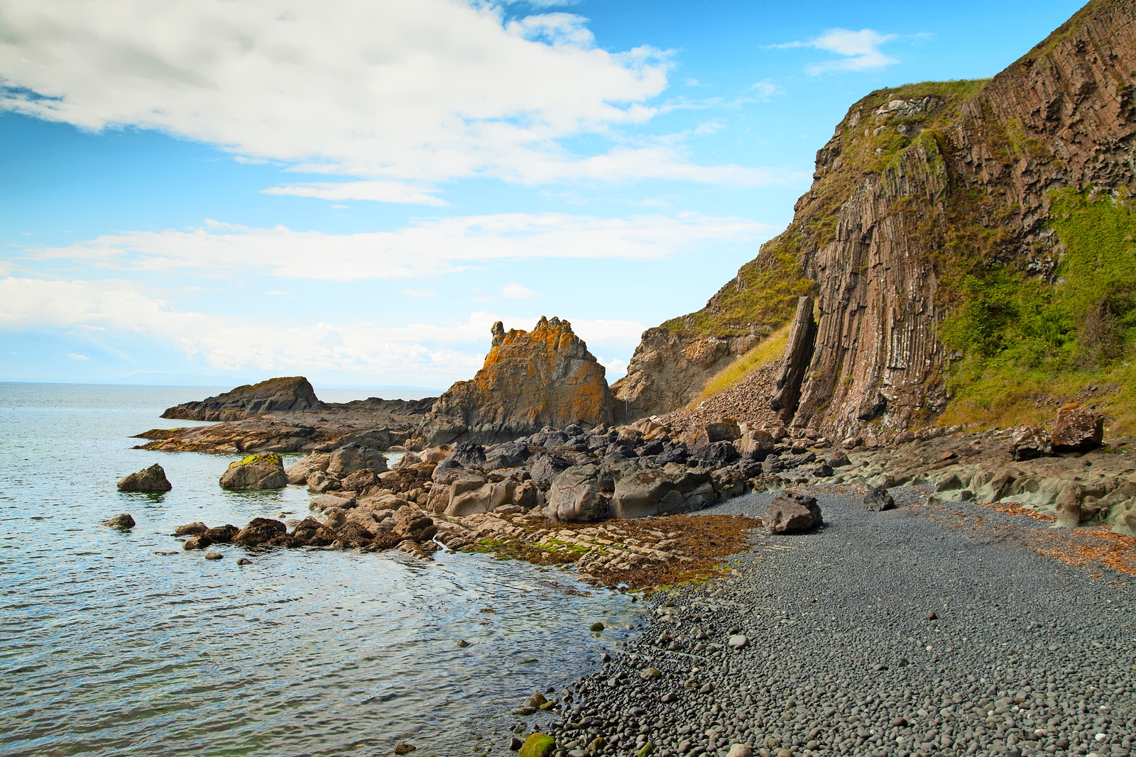 Pebble beach and rocky cliffs at Earlsferry Elie chain walk.