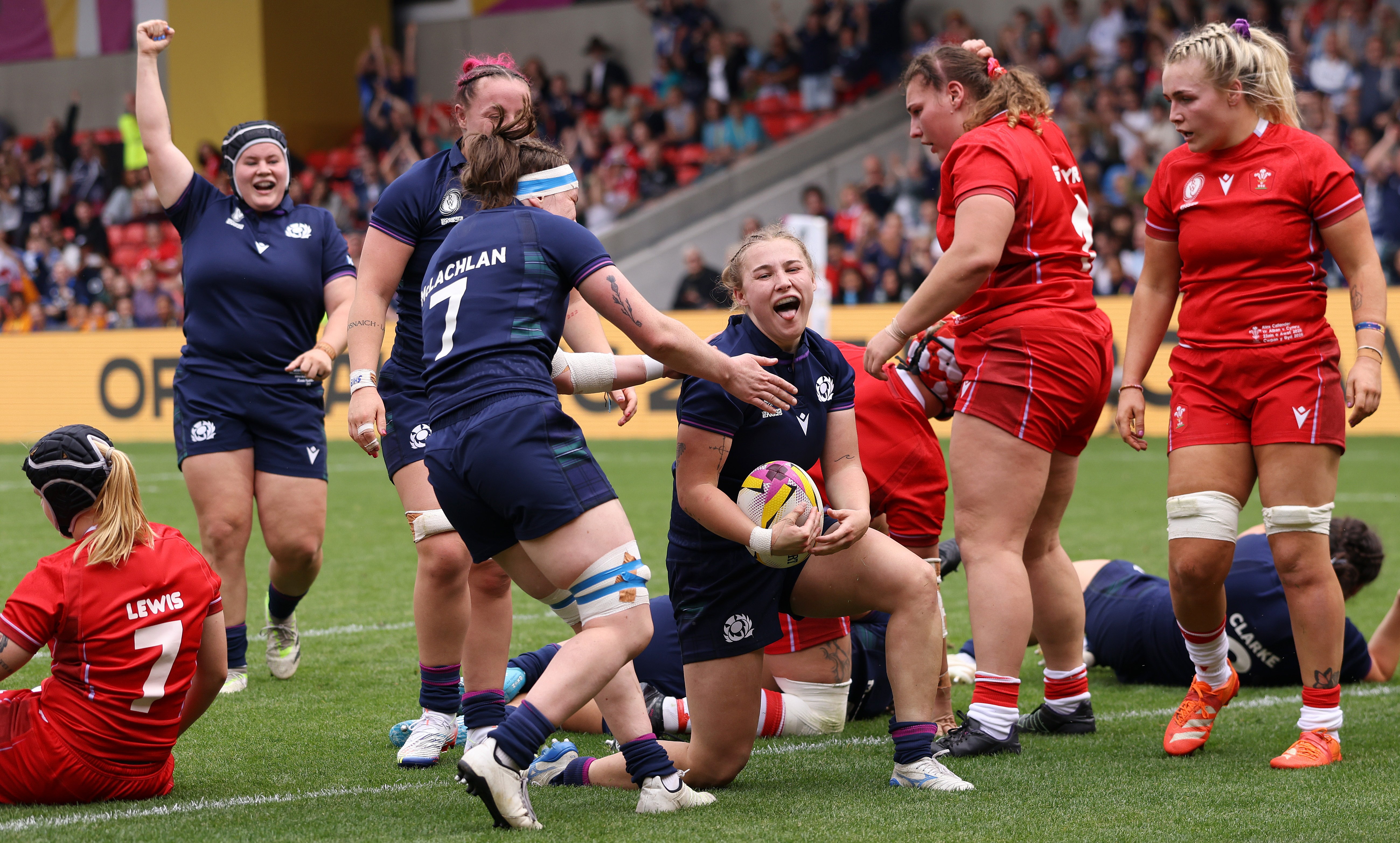 Scotland's Leia Brebner-Holden celebrates scoring a try during a Women's Rugby World Cup match against Wales.