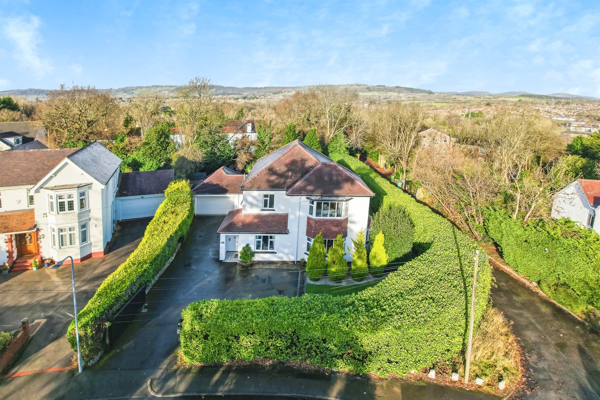 Aerial view of a house surrounded by hedges.
