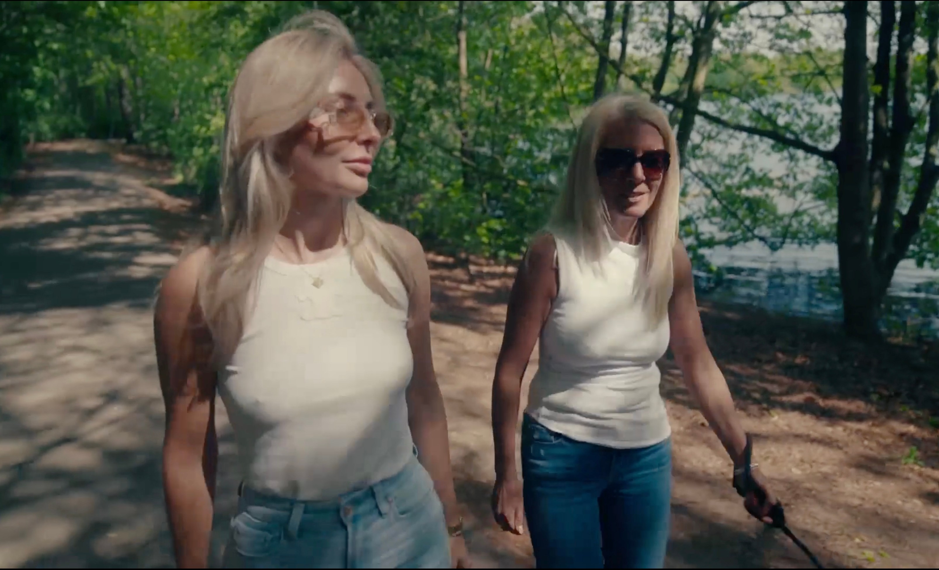 Bonnie and her mum walking in a park.