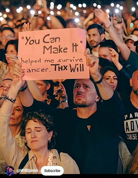 A fan at a Will Smith concert holds a sign thanking him for helping them survive cancer.
