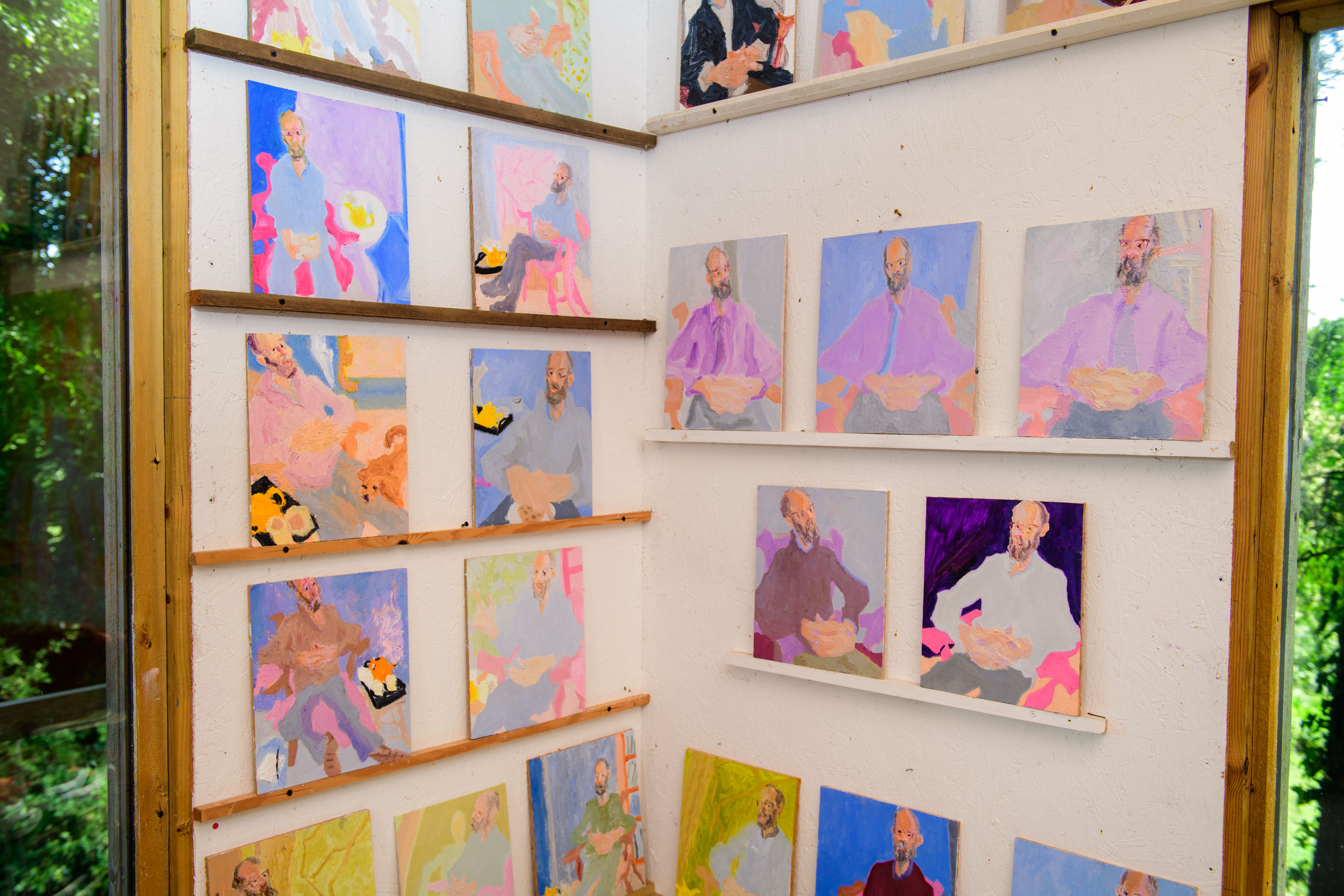 Paintings of a farmer displayed in an artist's studio.