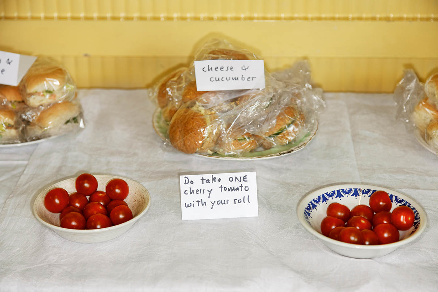 Sandwiches and bowls of cherry tomatoes at a church fête.