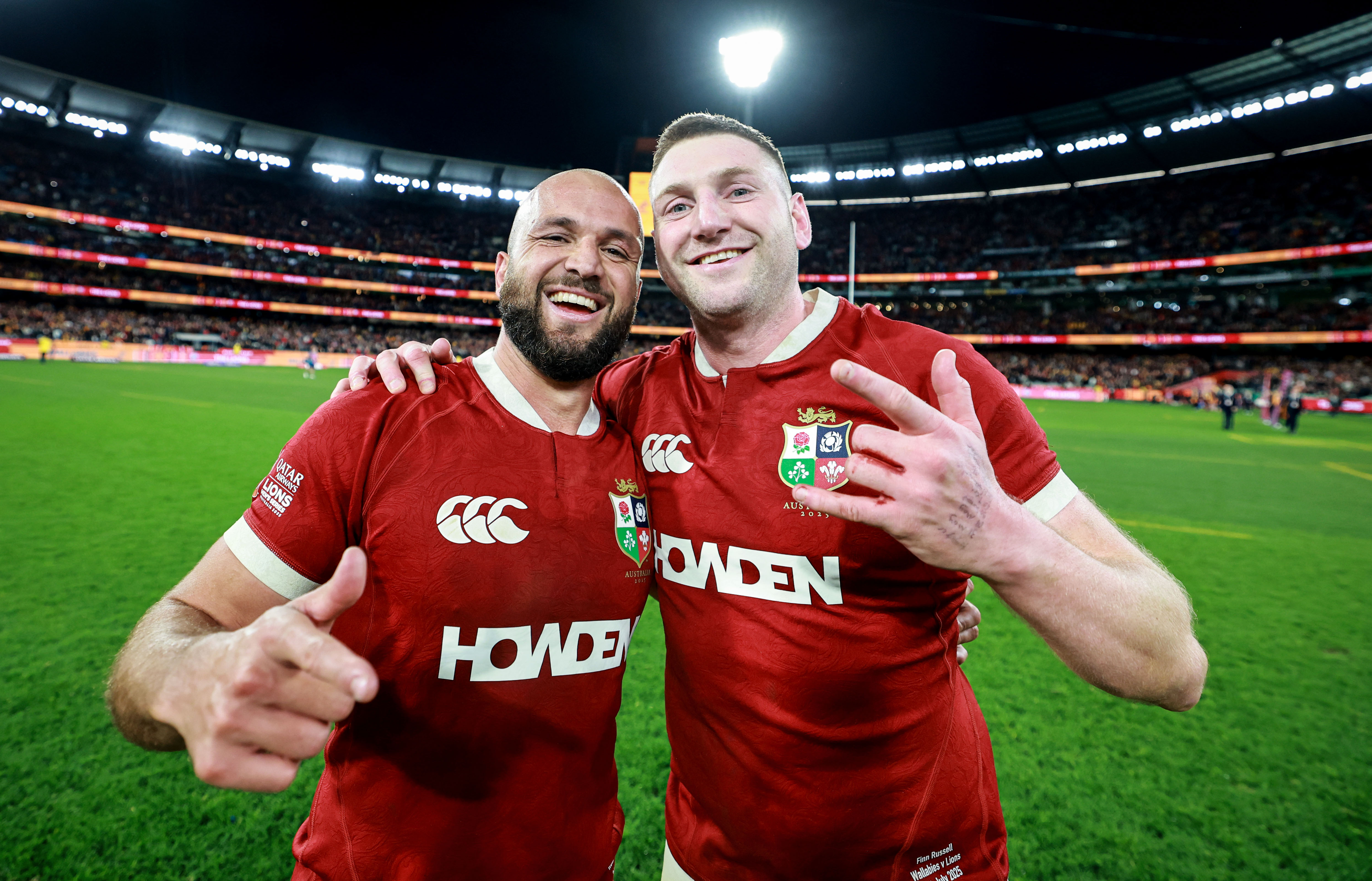 Jamison Gibson-Park and Finn Russell celebrating a rugby match victory.