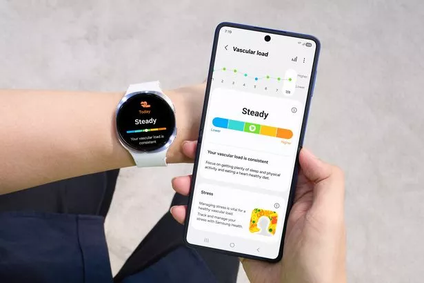 Person holding a phone wearing a white Samsung Galaxy smartwatch