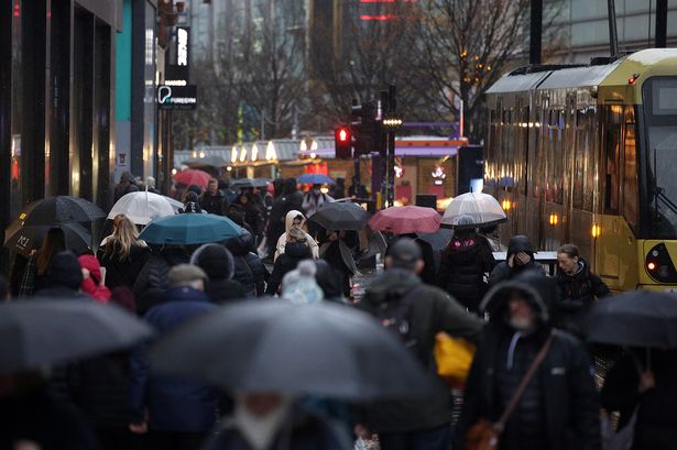 People walking in Manchester during a storm 