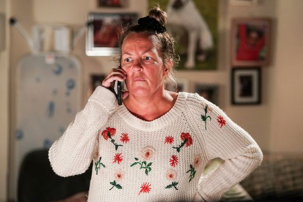 Lorraine stanley on phone as karen taylor in scene from eastenders