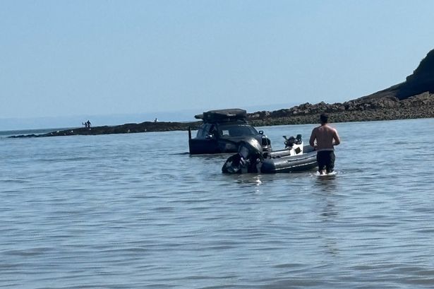  car stranded in the sea at Oxwich Bay