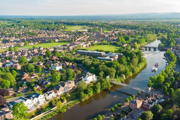 Aerial view of River Dee in Chester at dusk including Queens Park Bridge and The Old Dee Bridge, Cheshire, England, UK