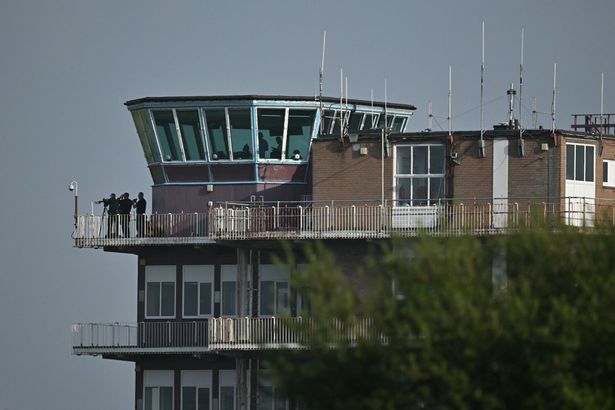 Armed cops at the air traffic control tower overlooking Glasgow Prestwick Airport amid Vance's arrival to Scotland