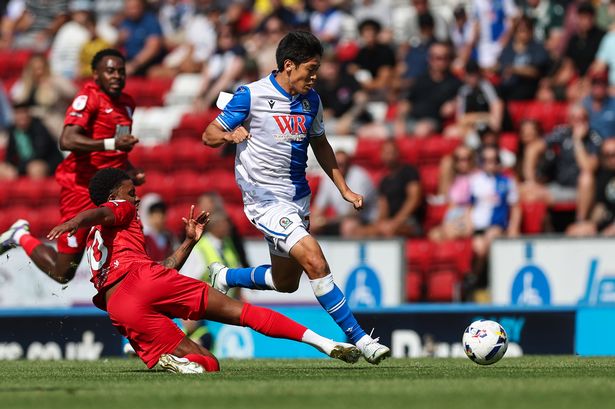  Blackburn Rovers' Yuki Ohashi passes the ball despite the attentions of Birmingham City's Demarai Gray