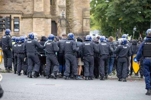 Protestors and police in Bolton on August 4 2024