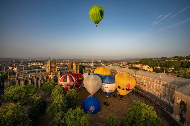 Hot air balloons take off from College Green