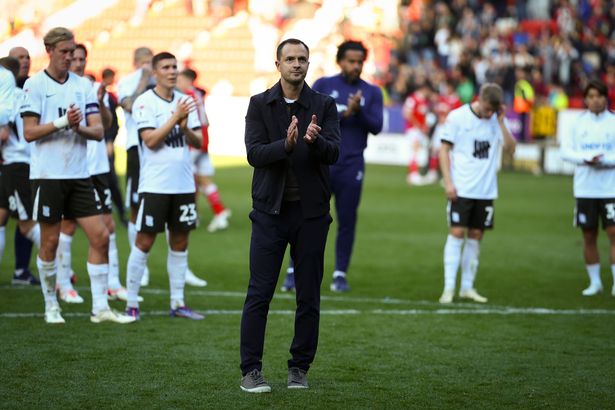 Chris Davies, manager of Birmingham City, applauds the club's fans.