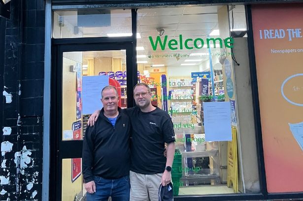 Colin Rimmer with his son Joe outside the shop in Penny Lane 