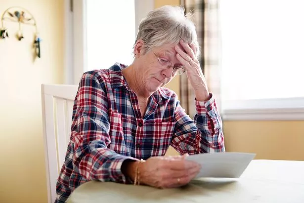 A Elderly woman worry about bill notice at home