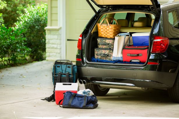 Family sport utility vehicle packed up in a driveway