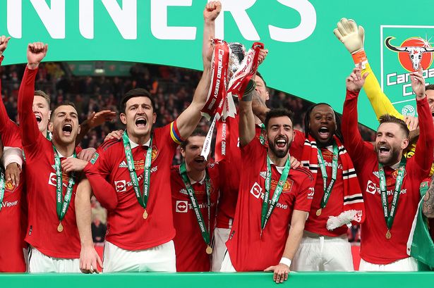 Bruno Fernandes and Harry Maguire of Manchester United lift the Carabao Cup trophy following victory in the Carabao Cup final against Newcastle United in 2023