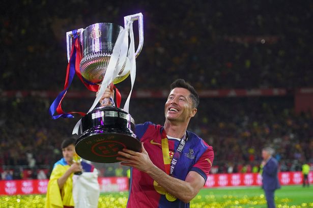 Robert Lewandowski lifts the La Liga trophy aloft.