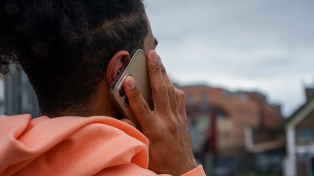 Young man using smart phone in urban setting