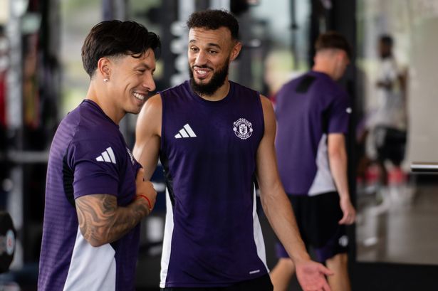 Noussair Mazraoui and Lisandro Martinez share a joke in the gym.