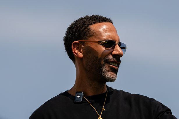 Rio Ferdinand watches during a first team training session