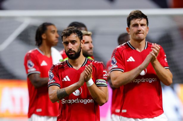 Manchester United captain Bruno Fernandes and Harry Maguire acknowledge the supporters after the draw with Everton