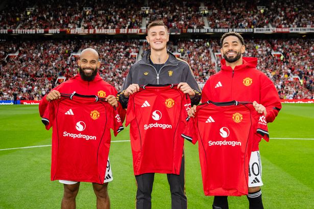 Manchester United trio Bryan Mbeumo, Benjamin Sesko and Matheus Cunha hold up their shirts in the Old Trafford centre circle.