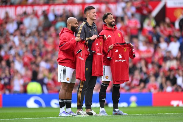 Bryan Mbeumo, Benjamin Sesko and Matheus Cunha hold up Manchester United shirts in the Old Trafford centre circle.