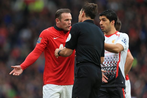  Wayne Rooney of Man Utd complains to referee Mark Clattenburg as Luis Suarez of Liverpool steps in during the Barclays Premier League match between Manchester United and Liverpool 