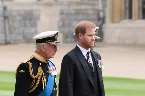 Britain's King Charles III (L) walks with his son Britain's Prince Harry, Duke of Sussex as they arrive at St George's Chapel inside Windsor Castle