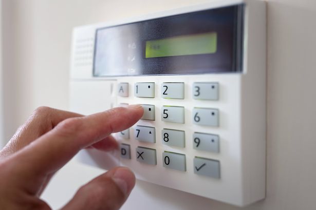 Security alarm keypad with person arming the system concept for crime prevention