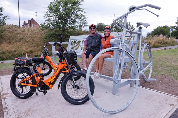 Cyclists Suzanne Friend and Malcolm Barnes from County Durham at the new sculpture by Ray Lonsdale in Tynemouth.