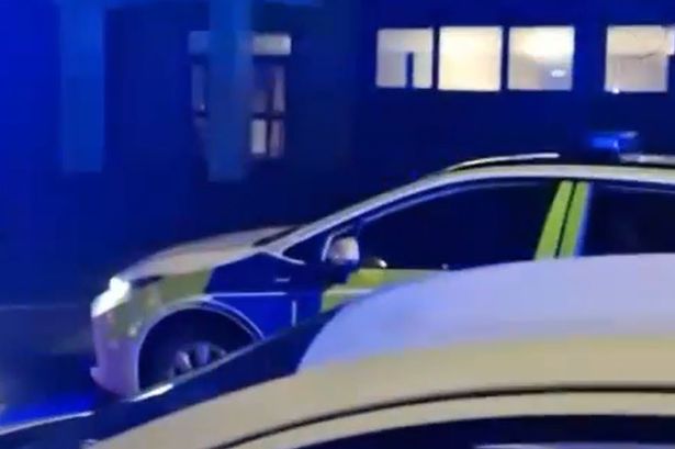 Police on Burford Road, in Whalley Range, on Thursday