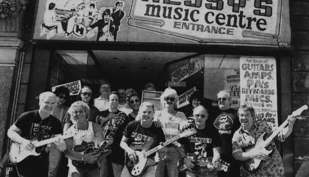 Musicians outside Hessy's Music Centre in 1995 on the last day of the store on Stanley Street